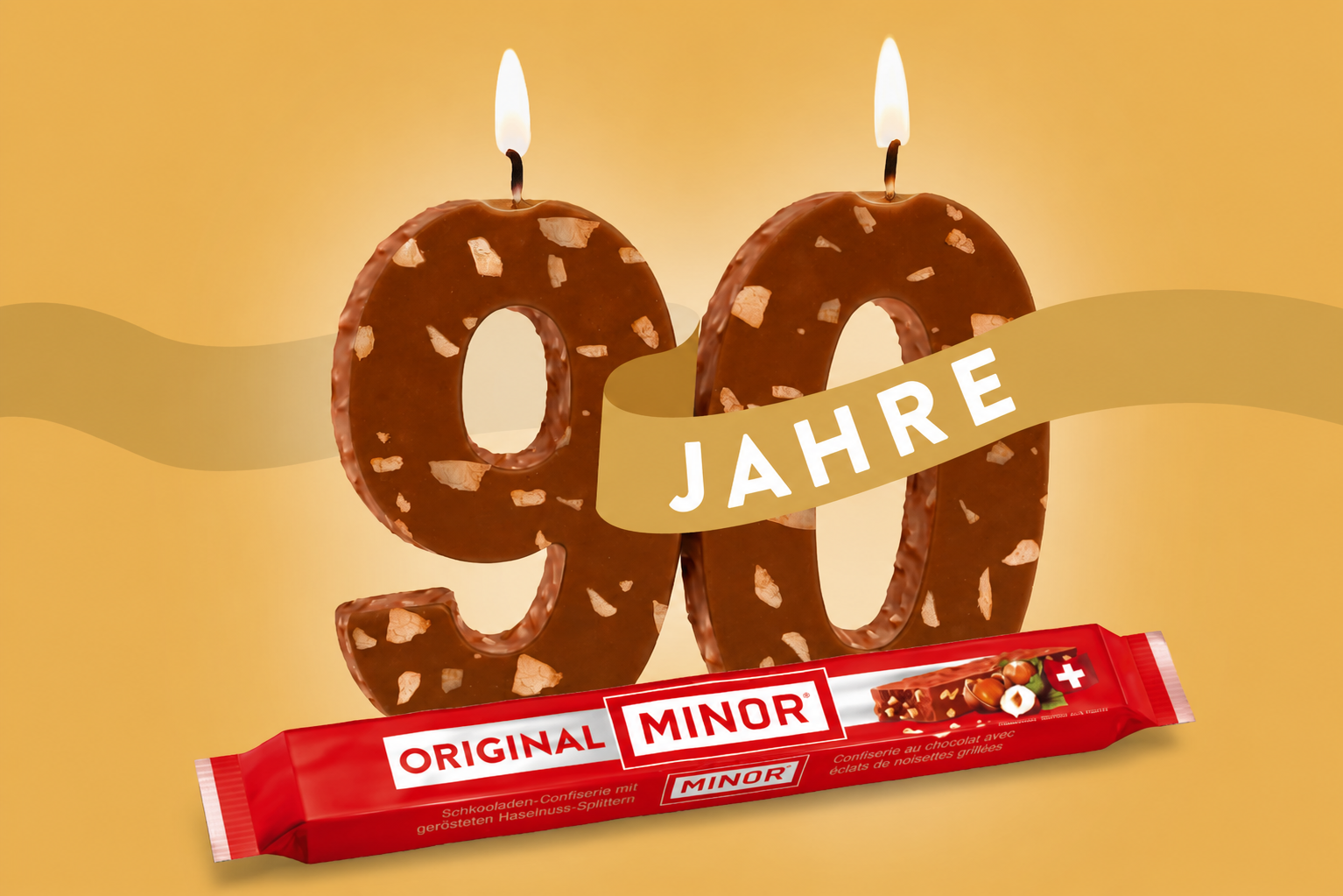 90 Jahre-Minor Logo mit Schokolade und Kerzen
